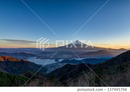 A spectacular view of Mt. Fuji and Lake Kawaguchi during magic hour. A spectacular view of Mt. Fuji and Lake Kawaguchi during magic hour. 137995798