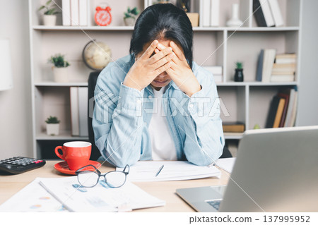 Stressed office worker covering face with hands at desk, overwhelmed by paperwork and laptop, financial anxiety, burnout, deadline pressure, mental health and work life balance concept. stressed Stressed office worker covering face with hands at desk, overwhelmed by paperwork and laptop, financial anxiety, burnout, deadline pressure, mental health and work life balance concept. stressed 137995952