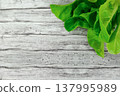 Healthy cooking backdrop with parsley and lettuce on wood 137995989