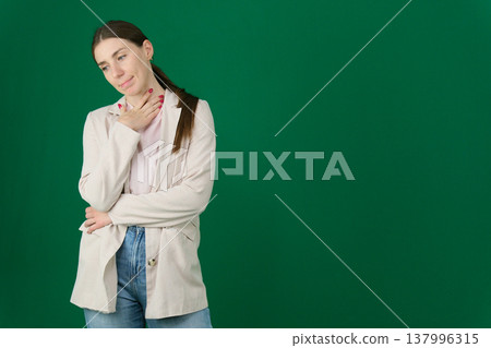 Young brazilian woman isolated on blue background and looking up Young brazilian woman isolated on blue background and looking up 137996315