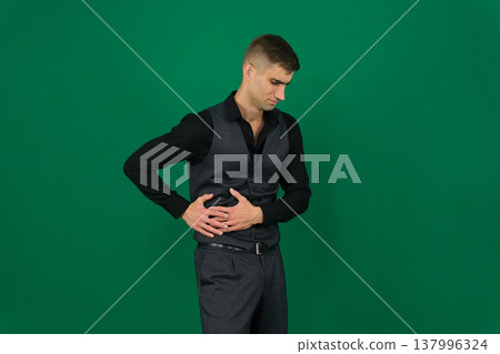 abdominal pain, A man touching his stomach for pain 137996324