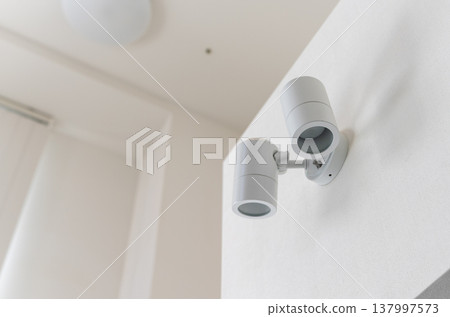 Spotlights mounted on a white wall Spotlights mounted on a white wall 137997573