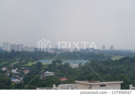 Cityscape Overlooking Lush Greenery in Cloudy Weather 137998087