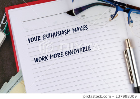 Inspirational words proclaim enthusiasm transforms tasks, neatly penned on a lined notebook page Inspirational words proclaim enthusiasm transforms tasks, neatly penned on a lined notebook page 137998309