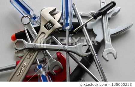 Different Hand Tools With Colored Handles In A Stack On White Surface Closeup Stock Photo Different Hand Tools With Colored Handles In A Stack On White Surface Closeup Stock Photo 138000238