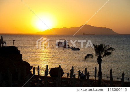 Seascape - the sun rises over the island early in the morning Seascape - the sun rises over the island early in the morning 138000443