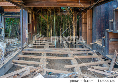 Demolition work on an old vacant house; bamboo is growing underneath the floorboards that have been removed. Demolition work on an old vacant house; bamboo is growing underneath the floorboards that have been removed. 138000480