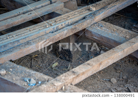 Demolition work on an old vacant house: The floorboards have been removed from the crawl space underneath. Demolition work on an old vacant house: The floorboards have been removed from the crawl space underneath. 138000491