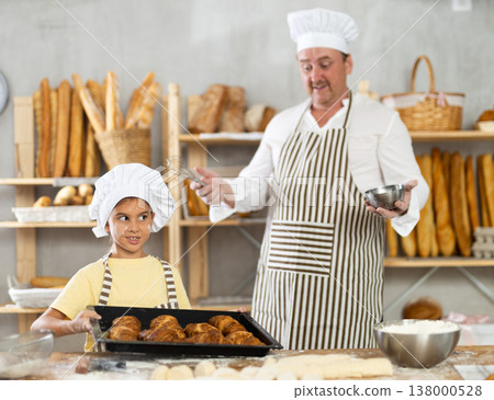 Surprised father looks at cooked croissants, rejoices at result of daughters work Surprised father looks at cooked croissants, rejoices at result of daughters work 138000528