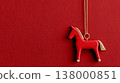 Red horse ornament hanging against textured red background for Chinese New Year celebration 138000851