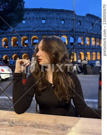 Evening at Colosseum Italy young woman enjoying Aperol with strawberries clinking glasses relaxing lifestyle travel luxury urban Evening at Colosseum Italy young woman enjoying Aperol with strawberries clinking glasses relaxing lifestyle travel luxury urban 138000970