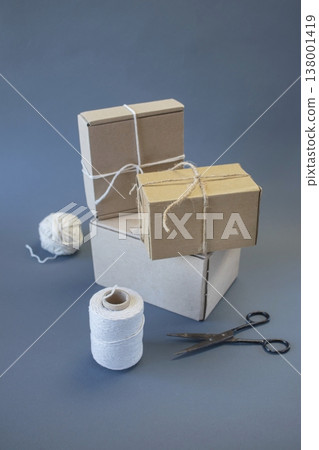 Cardboard boxes and packing twine, delivery concept. Stacking of postal cardboard boxes and packing twine. 138001419