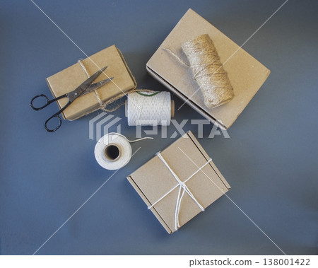 Cardboard boxes and packing twine, delivery concept. Stacking of postal cardboard boxes and packing twine. 138001422