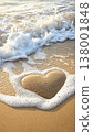 Close up of a pebble heart on a serene beach, embraced by soft sands and gentle waves 138001848