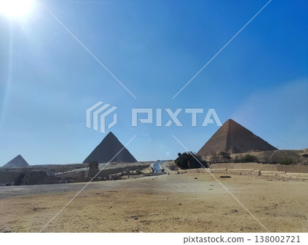 Panoramic Landscape of Giza Pyramids and Desert Sands under Bright Blue Sky 138002721