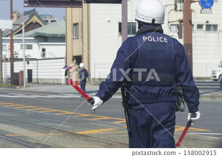 A police officer directing traffic in the city. A police officer directing traffic in the city. 138002915