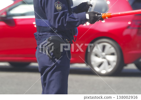 A police officer directing traffic in the city. A police officer directing traffic in the city. 138002916