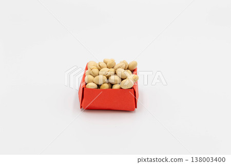 Soybeans in a red origami box, reminiscent of lucky beans for Setsubun (bean-throwing festival), against a white background. 138003400