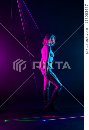 Futuristic cyberpunk woman in neon laser light show Futuristic cyberpunk woman in neon laser light show 138003427