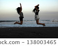 Silhouette of a young woman jumping 138003465
