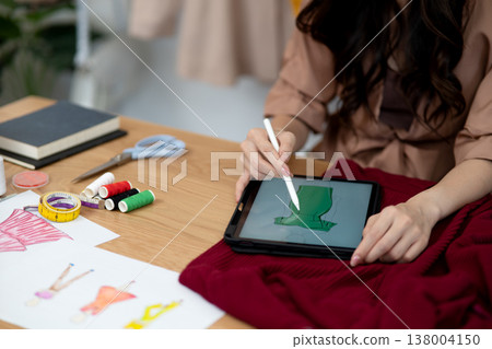 young woman designer drawing clothes design 138004150