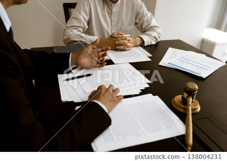 Lawyer pointing to document and discussing legal text in lawsuit 138004231