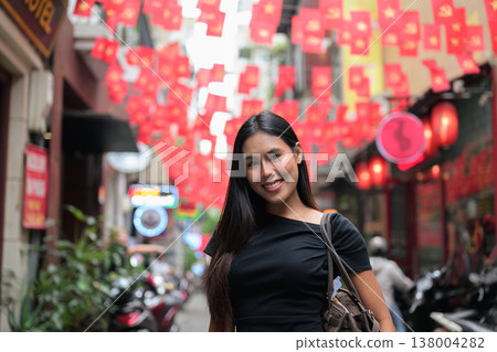 Young Thai Woman on Hanoi Old Quarter Street with Vietnamese Flags 138004282