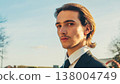 Young confident businessman looking to the camera, outdoors. Portrait of the Handsome White man with brown hair,  in the city, on summer. Stylish man in business suit, on the street. People lifestyle 138004749