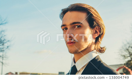 Young confident businessman looking to the camera, outdoors. Portrait of the Handsome White man with brown hair,  in the city, on summer. Stylish man in business suit, on the street. People lifestyle 138004749