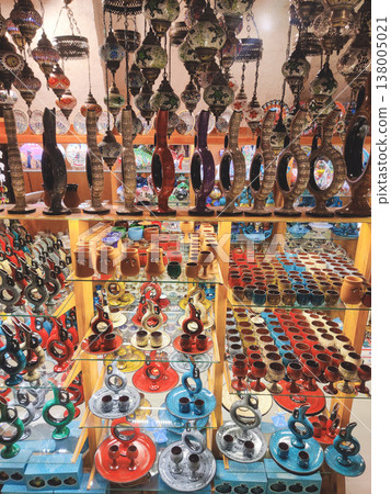 Traditional Turkish pottery and colorful mosaic lamps in a souvenir shop 138005021