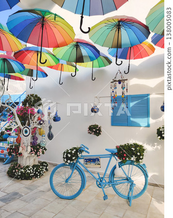 Decorative street scene with rainbow umbrellas and a blue bicycle in Bodrum, Turkey 138005083