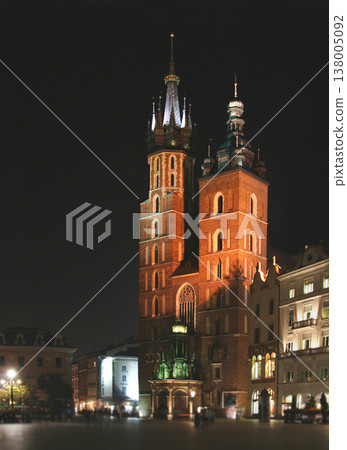 Illuminated Gothic facade of Saint Mary's Basilica at night in the historic Main Market Square of Krakow Illuminated Gothic facade of Saint Mary's Basilica at night in the historic Main Market Square of Krakow 138005092