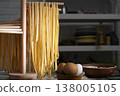 Homemade noodles hanging on wooden noodle dryer rack. Home cooking concept 138005105