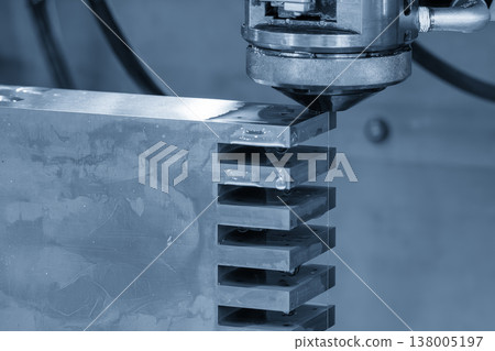Close-up of a high-precision Wire EDM cutting process on a metal workpiece in a smart factory environment. Close-up of a high-precision Wire EDM cutting process on a metal workpiece in a smart factory environment. 138005197