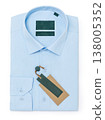 Plain light blue folded men's long-sleeved button shirt insulated against white background, top view 138005352