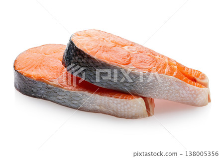 Two fresh raw salmon steaks lying on each other isolated on white background, sharpness across the entire object 138005356