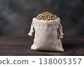 Combination feed in the form of bird pellets in a bag on a wooden table, authentic photograph, not AI-generated 138005357