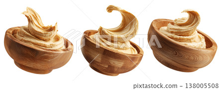Swirled creamy hummus in wooden bowl, isolated on white transparent background. Concept of healthy vegan food and dip Swirled creamy hummus in wooden bowl, isolated on white transparent background. Concept of healthy vegan food and dip 138005508