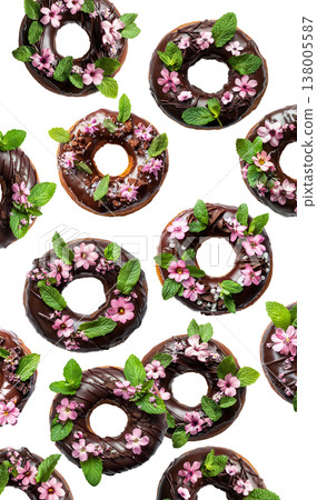 Chocolate glazed donuts topped with pink edible flowers and mint leaves, isolated on a white background Chocolate glazed donuts topped with pink edible flowers and mint leaves, isolated on a white background 138005587