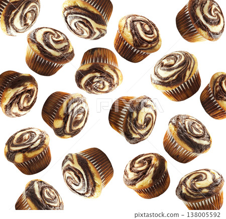 Delicious chocolate marble muffins in scattered layout, isolated on white background. Concept of sweet bakery treats 138005592