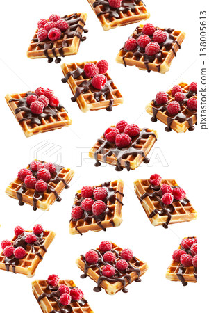 Belgian waffles with raspberries and chocolate isolated on white background as concept of tasty dessert Belgian waffles with raspberries and chocolate isolated on white background as concept of tasty dessert 138005613