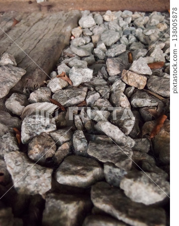Extreme close-up view of the rocks on the old railway. Different shape of rocks on the railway. Full of rocks. Rock/stone background. Extreme close-up view of the rocks on the old railway. Different shape of rocks on the railway. Full of rocks. Rock/stone background. 138005878