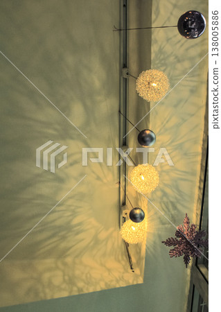 Decorative lamps hanging on the ceiling with the shadow on the wall. Interiors decoration. Decorative lamps hanging on the ceiling with the shadow on the wall. Interiors decoration. 138005886