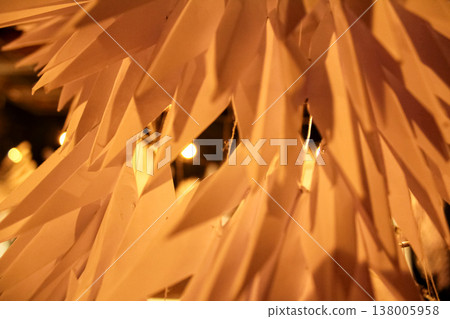 Close-up of the paper decor under the warm tone light. Paper texture, pattern. Close-up of the paper decor under the warm tone light. Paper texture, pattern. 138005958