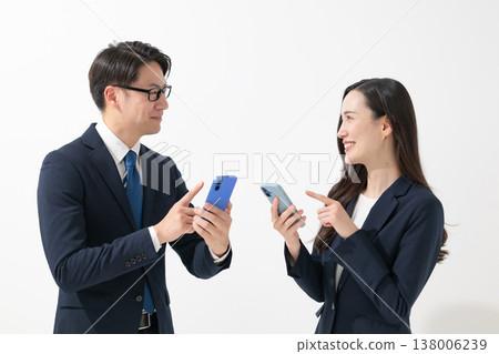 Businessman and businesswoman with smartphones Businessman and businesswoman with smartphones 138006239