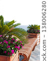 Cozy Outdoor Bench Surrounded By Nature. Serene Seating Area With Colorful Flowers By Gentle Sea 138006280