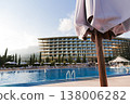 Outdoor Pool And Landscaped Surroundings. Vacation Setting With Sunlit Balcony And Lush Landscaping 138006282