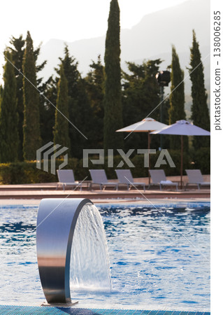 Serene Poolside Relaxation Setting. Idyllic Spa Environment With Scenic Views And Tranquil Ambiance Serene Poolside Relaxation Setting. Idyllic Spa Environment With Scenic Views And Tranquil Ambiance 138006285