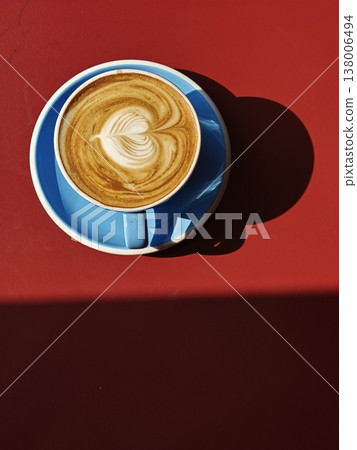 Latte Art Top View Blue Cup Red Background Portrait Latte Art Top View Blue Cup Red Background Portrait 138006494