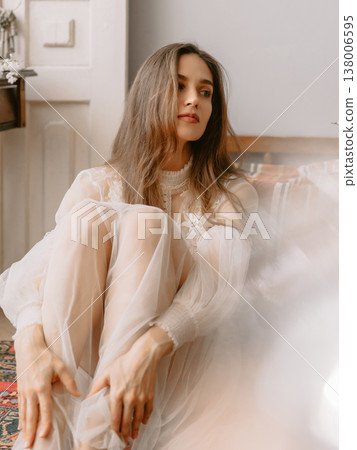 Dreamy portrait of young woman in boudoir dress, soft smile and romantic vintage mood. Dreamy portrait of young woman in boudoir dress, soft smile and romantic vintage mood. 138006595